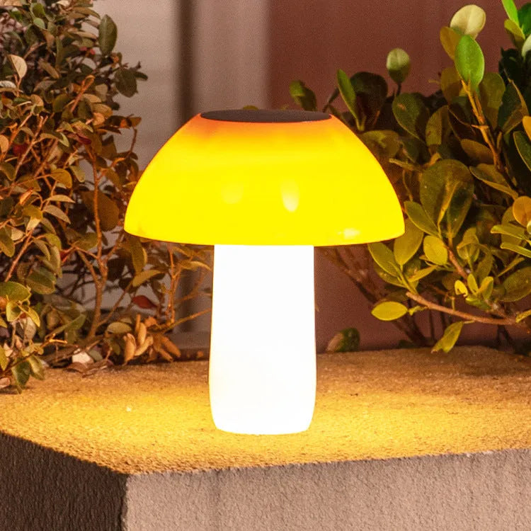 Solar garden mushroom light with ground spike for lawn and pathway illumination.