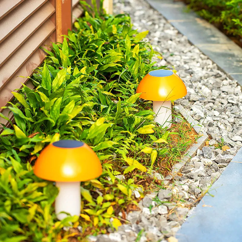 Solar garden mushroom light with ground spike for lawn and pathway illumination.