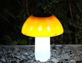 Solar garden mushroom light with ground spike for lawn and pathway illumination.