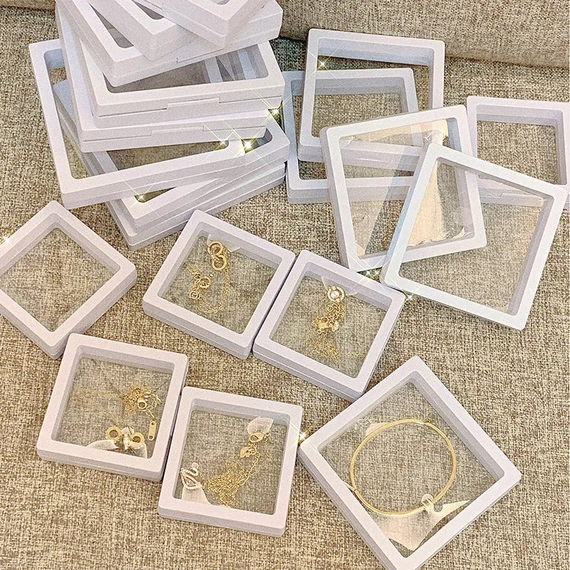 3D floating display case holding coins and jewellery between transparent membrane sheets