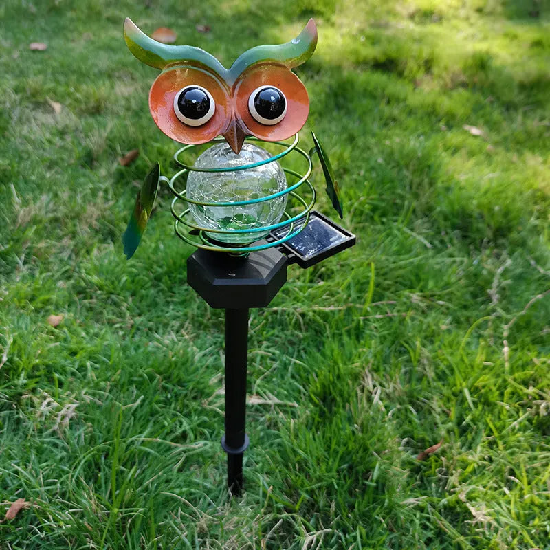 Solar owl lawn lamp with blue LED glow in garden pathway setting, 45cm tall