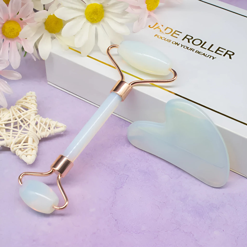 Aventurine face roller with opal heart design on a flat surface