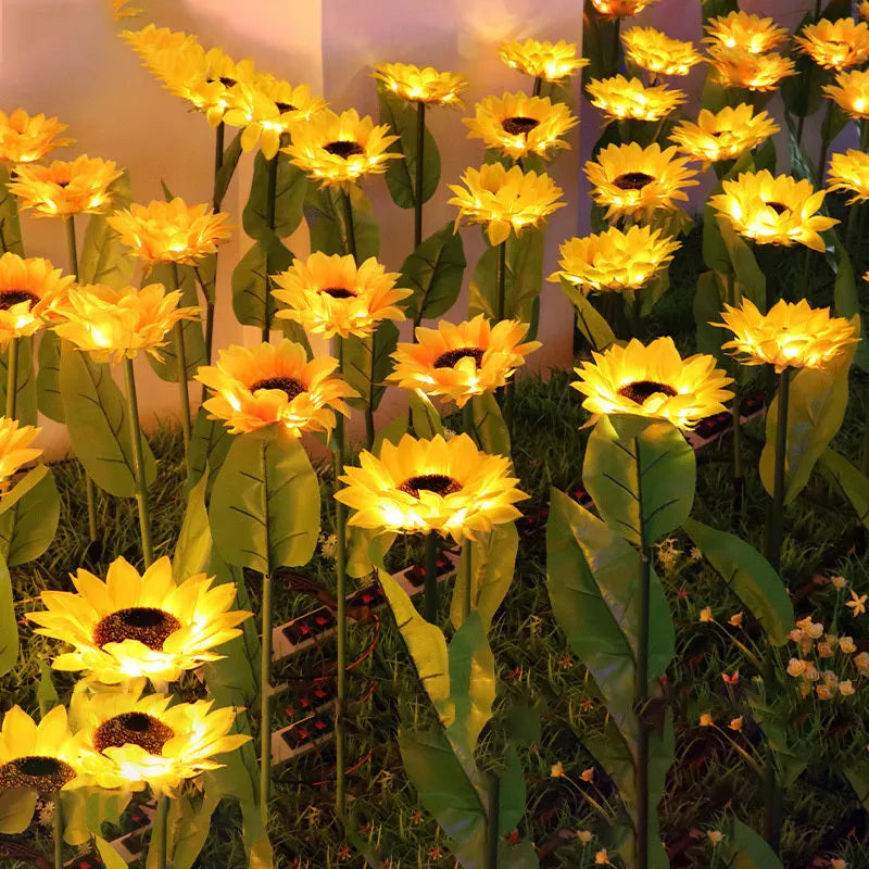 Set of LED solar sunflower garden lights with yellow Bujuan flower heads and stainless steel stems placed along a pathway
