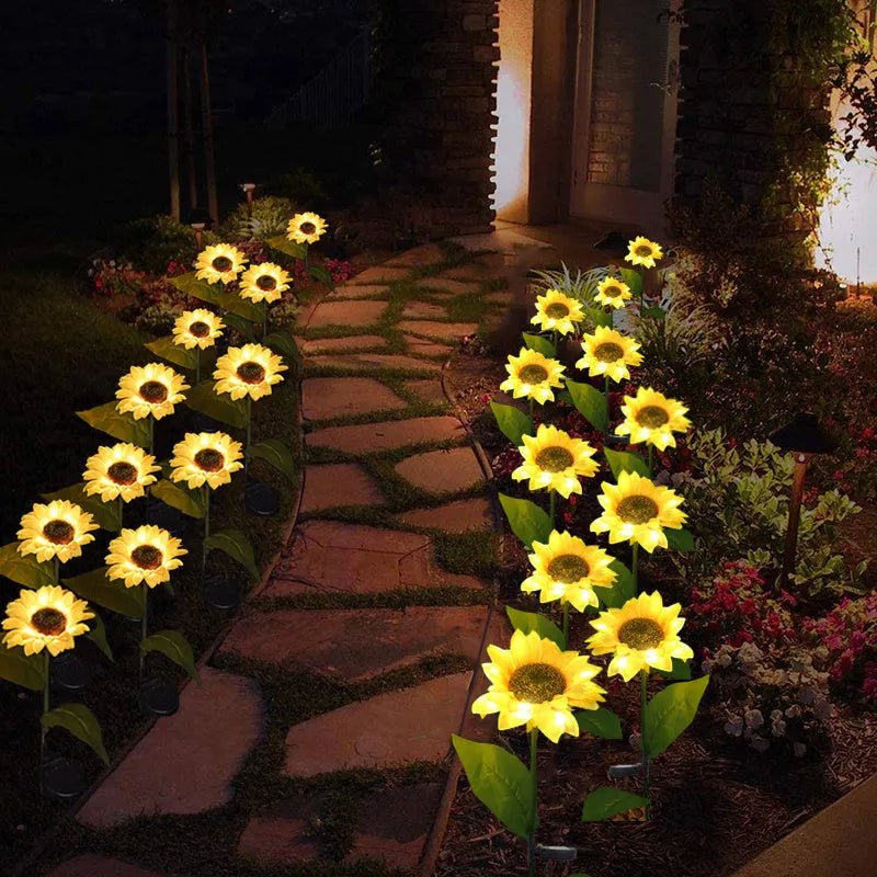 Set of LED solar sunflower garden lights with yellow Bujuan flower heads and stainless steel stems placed along a pathway