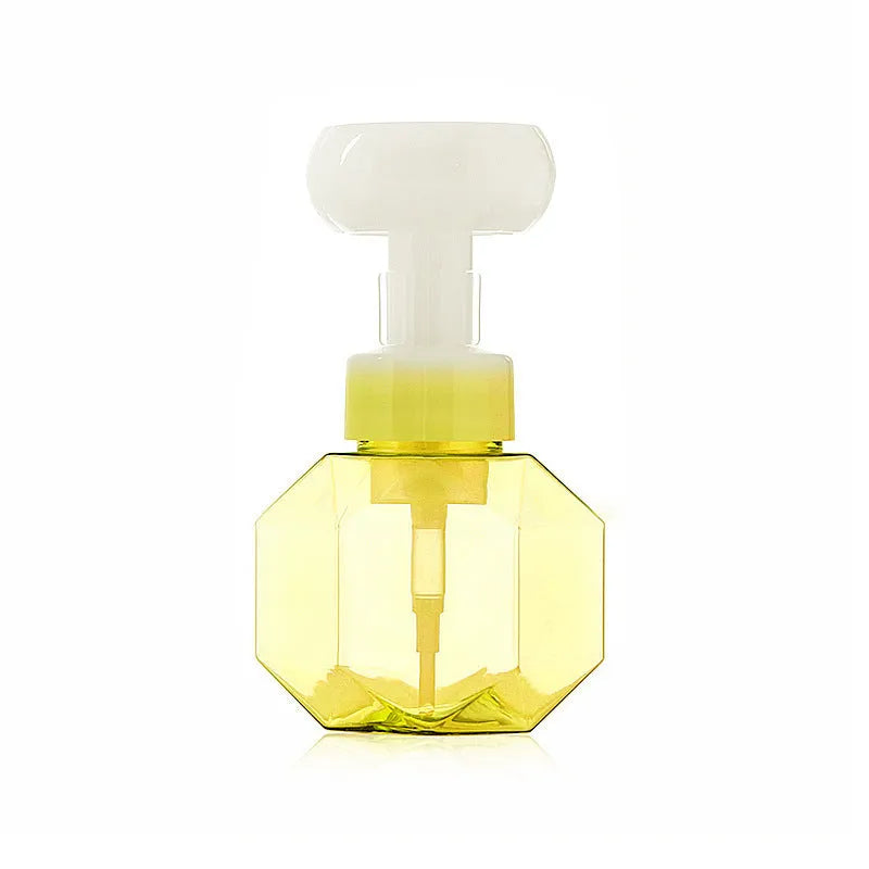 Refillable plastic foaming bottle for liquid soap in blue, green, pink and yellow colours.