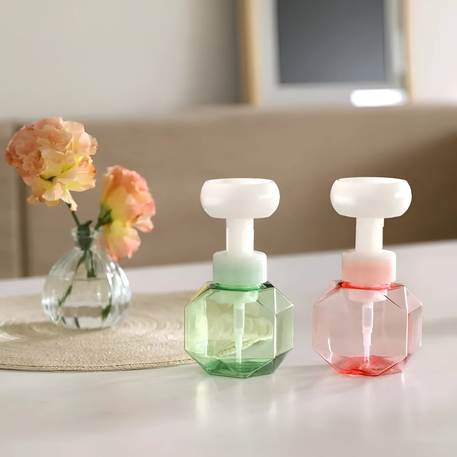 Refillable plastic foaming bottle for liquid soap in blue, green, pink and yellow colours.