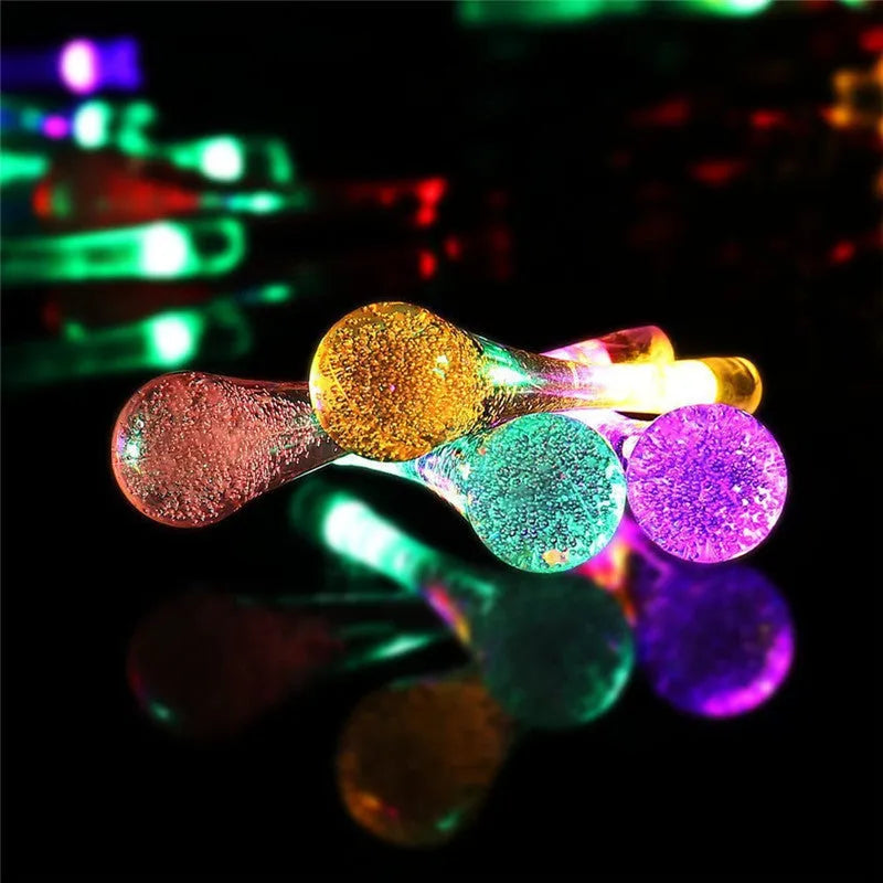 Solar-powered outdoor LED string lights with water drop pendants on 6.5m cable