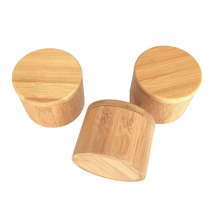 Bamboo seasoning storage box with a small bamboo spoon on a kitchen counter.