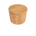 Bamboo seasoning storage box with a small bamboo spoon on a kitchen counter.