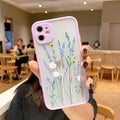Matte pink lavender iPhone case with blue floral cartoon design and contrasting coloured frame.