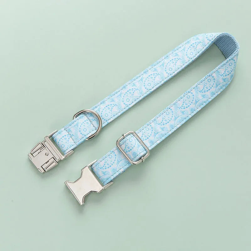 Paisley polyester dog collar with zinc alloy buckle and lettering on a white background.