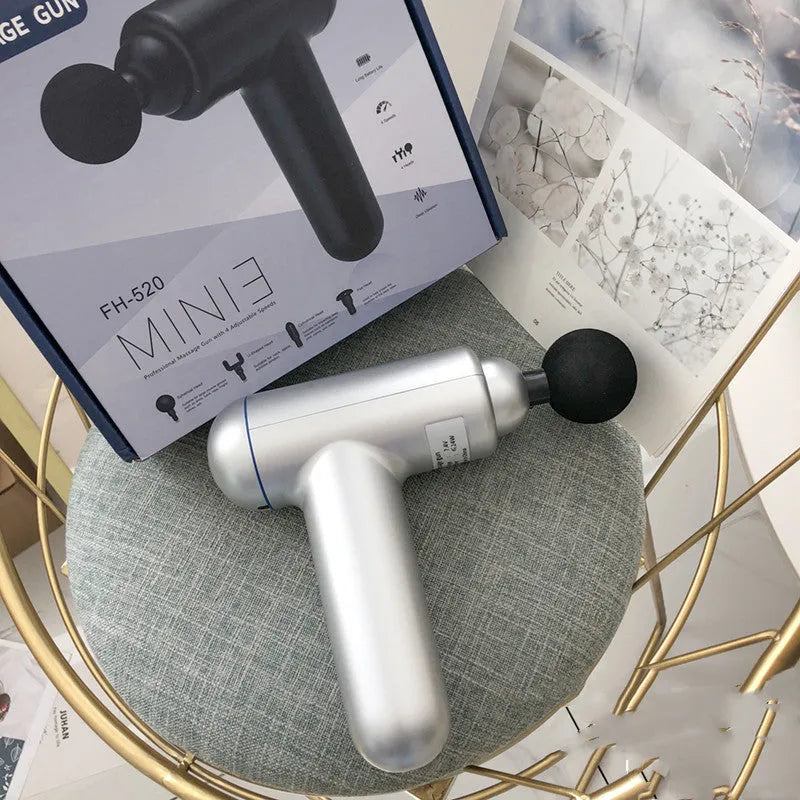 Black handheld fascia gun muscle massager on a grey background