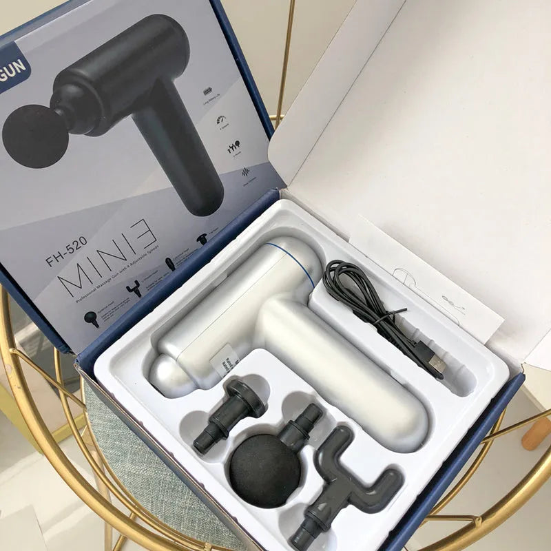 Black handheld fascia gun muscle massager on a grey background