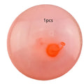 Large pink TPR inflatable bouncy ball for children's outdoor play, shown with a pump