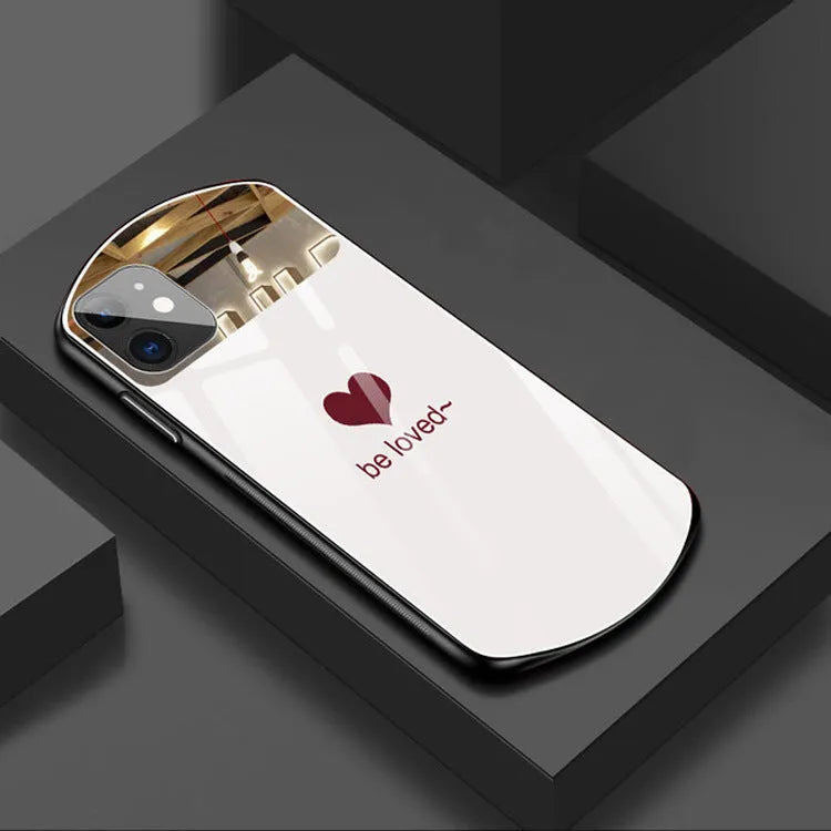 Black phone case for iPhone with a rectangular mirror on the back and letter graphic design.