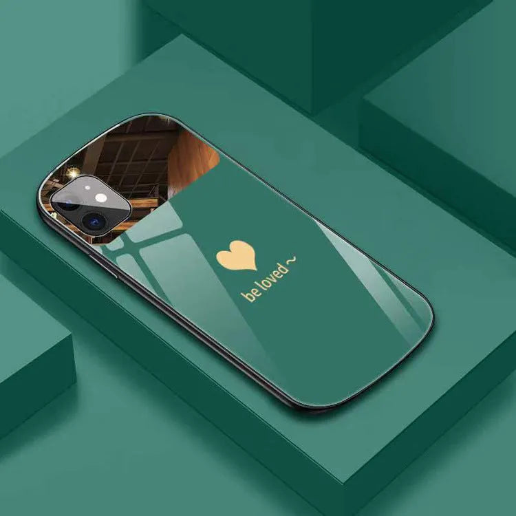 Black phone case for iPhone with a rectangular mirror on the back and letter graphic design.