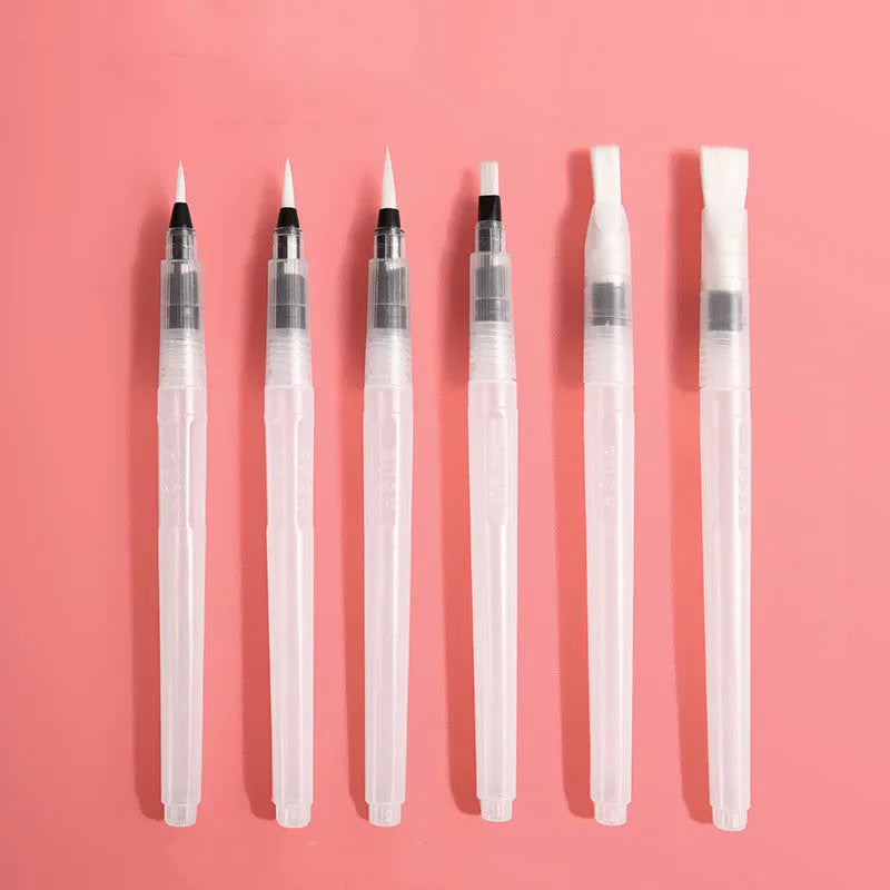 Open fan-shaped foldable solid watercolour paint set showing colours, fountain pen, palette, and sponge in transparent box.