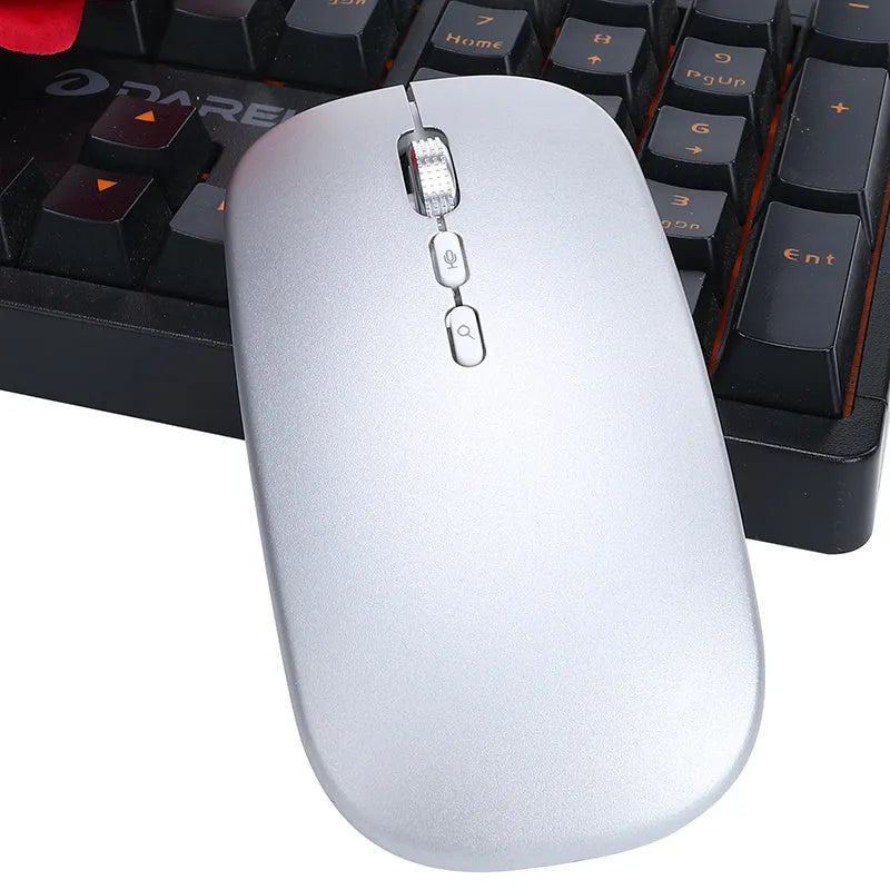 Silver intelligent voice mouse with voice typing translation and wireless charging on desk