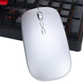 Silver intelligent voice mouse with voice typing translation and wireless charging on desk
