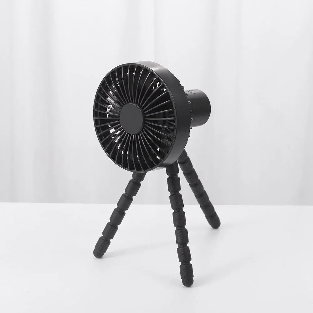 Adjustable tripod desktop fan with a bending head in black, shown in handheld and desktop positions.