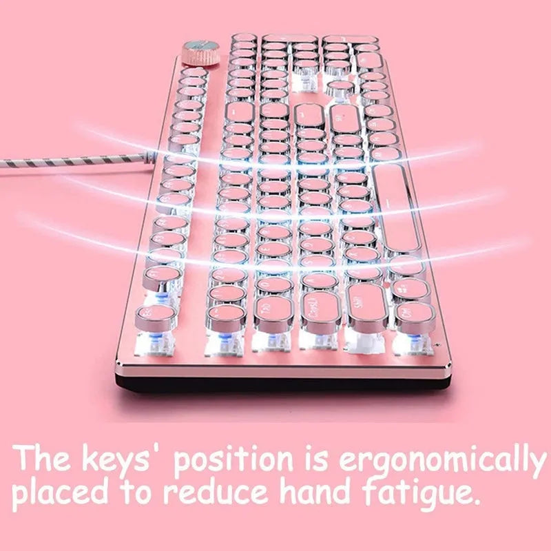 Silver and pink mechanical keyboard with green switches and white backlighting on a desk.