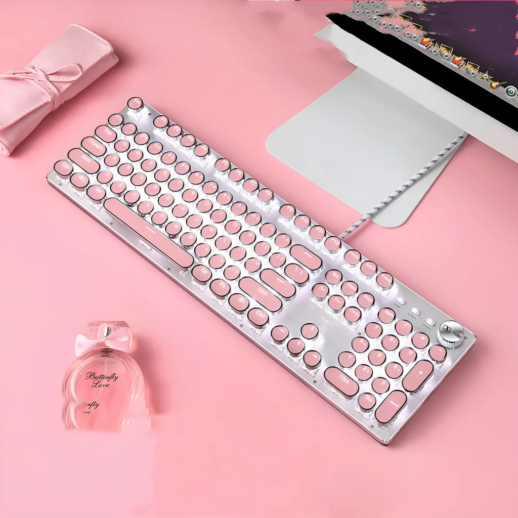 Silver and pink wired mechanical keyboard with green switches and white backlight alongside a mouse on a desk.