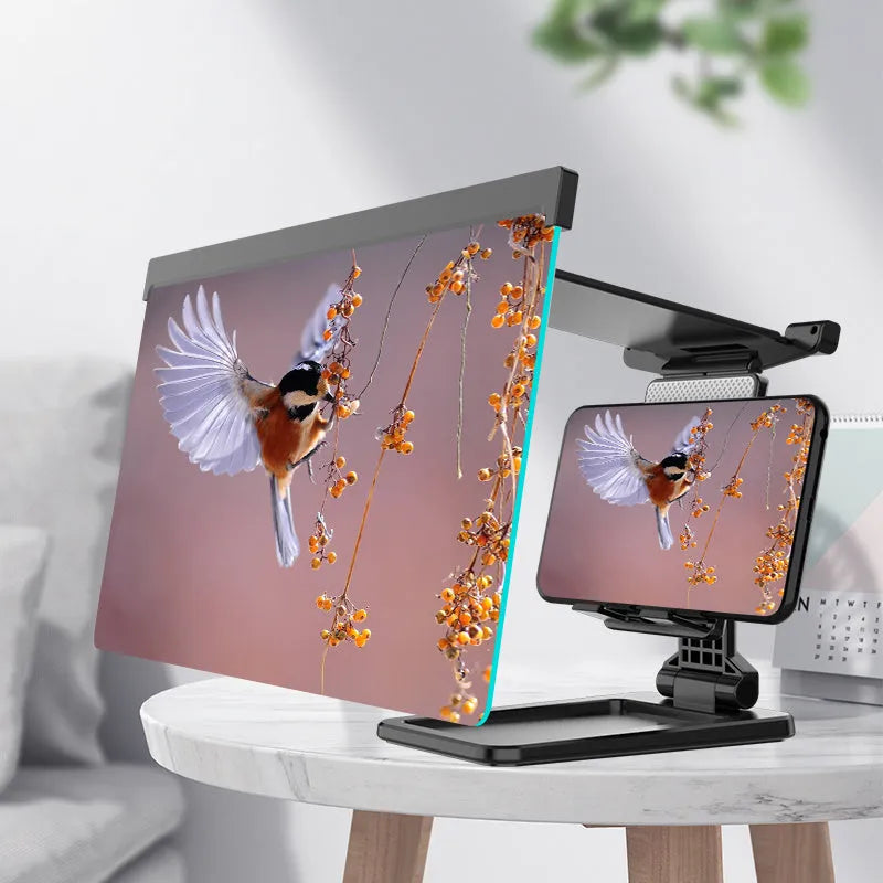 Black folding mobile phone screen amplifier with detached phone holder on a desk