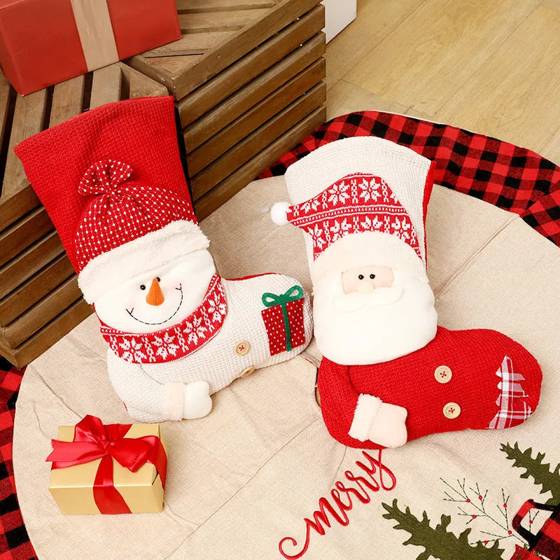 Large red and white knitted Christmas stocking with Santa Claus design hanging on fireplace