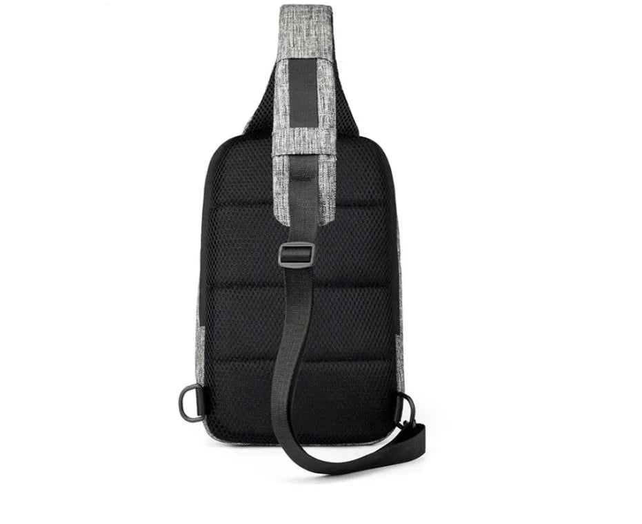Small dark blue oxford cloth chest bag with a zipper and adjustable strap, showing internal phone pocket.