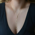 Gold colour alloy geometric pendant necklace with snake bone chain on display