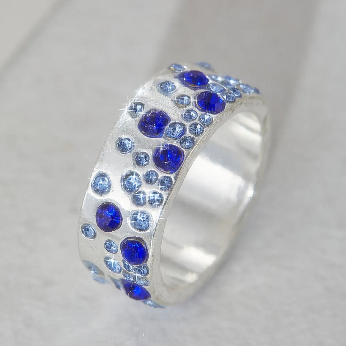 Mixed colour diamond retro personality ring in unisex geometric style on a white background.