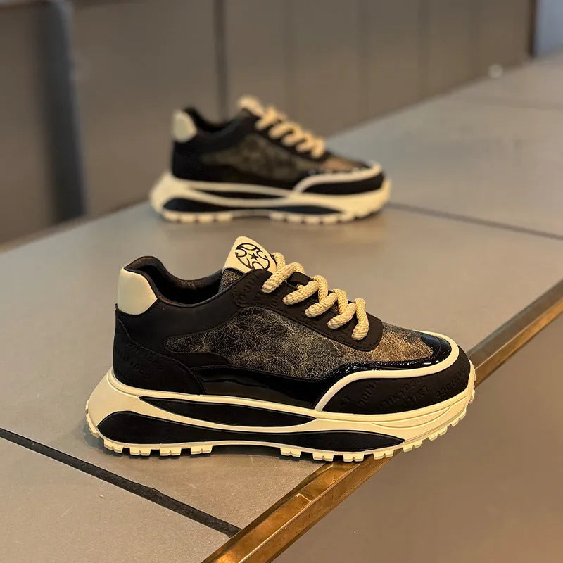 Pair of black retro lace-up daddy shoes with a thick rubber sole and rounded toe.