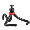 Black octopus tripod with flexible rubber legs wrapped around a pole holding a camera