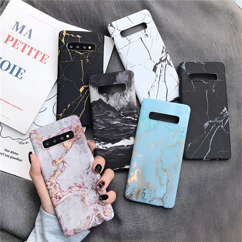 Samsung Galaxy phone in a PC case with a white and grey marble pattern on the back.