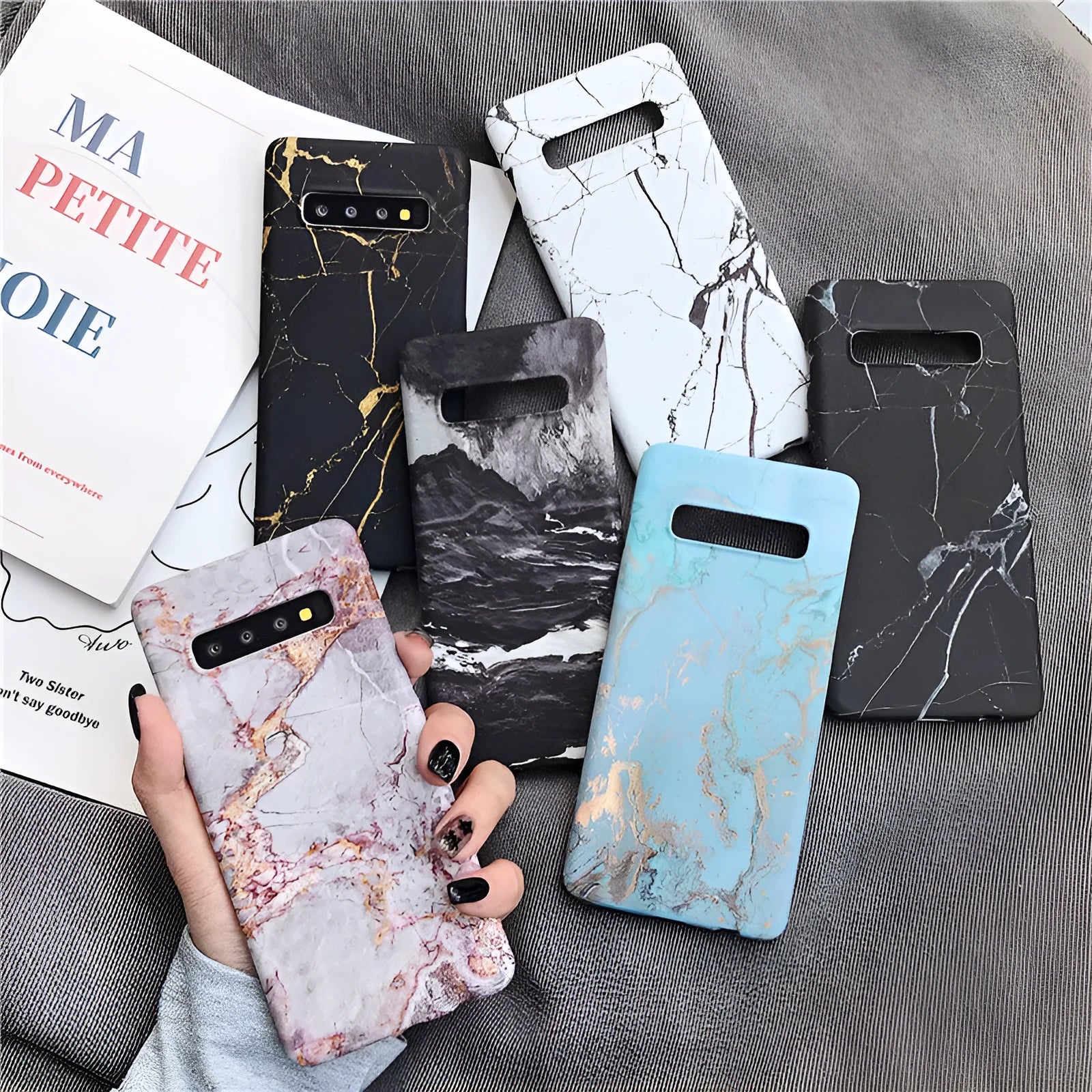 Samsung Galaxy phone in a PC case with a white and grey marble pattern on the back.