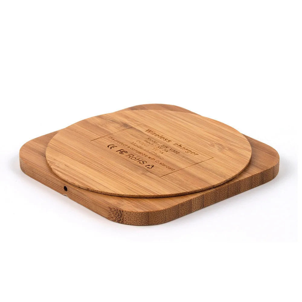 Square bamboo wood 5W wireless charger on a wooden surface.