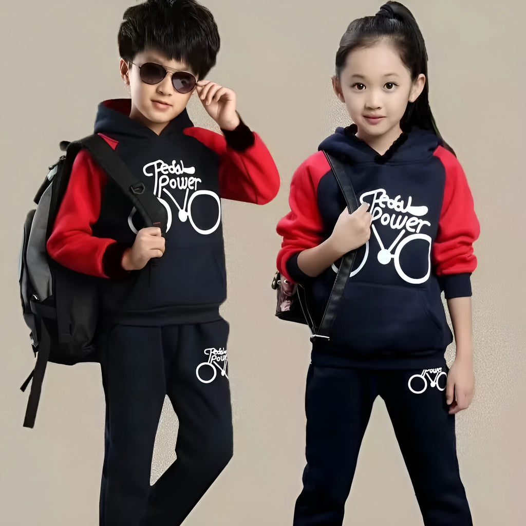 Older child wearing a black two-piece sports suit with long sleeves and print detail.