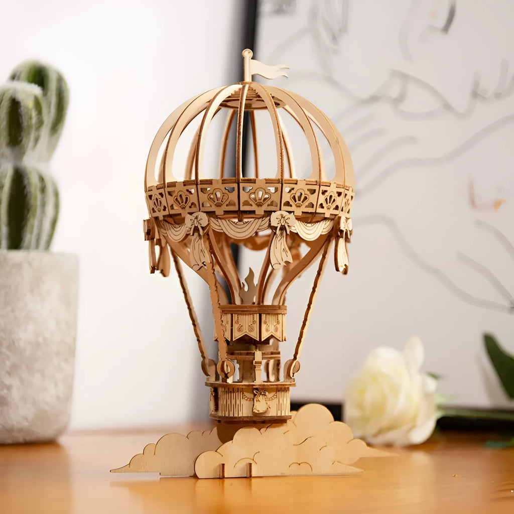 Assembled wooden 3D puzzle model of a Pumpkin Carriage on a white surface, laser-cut plywood construction