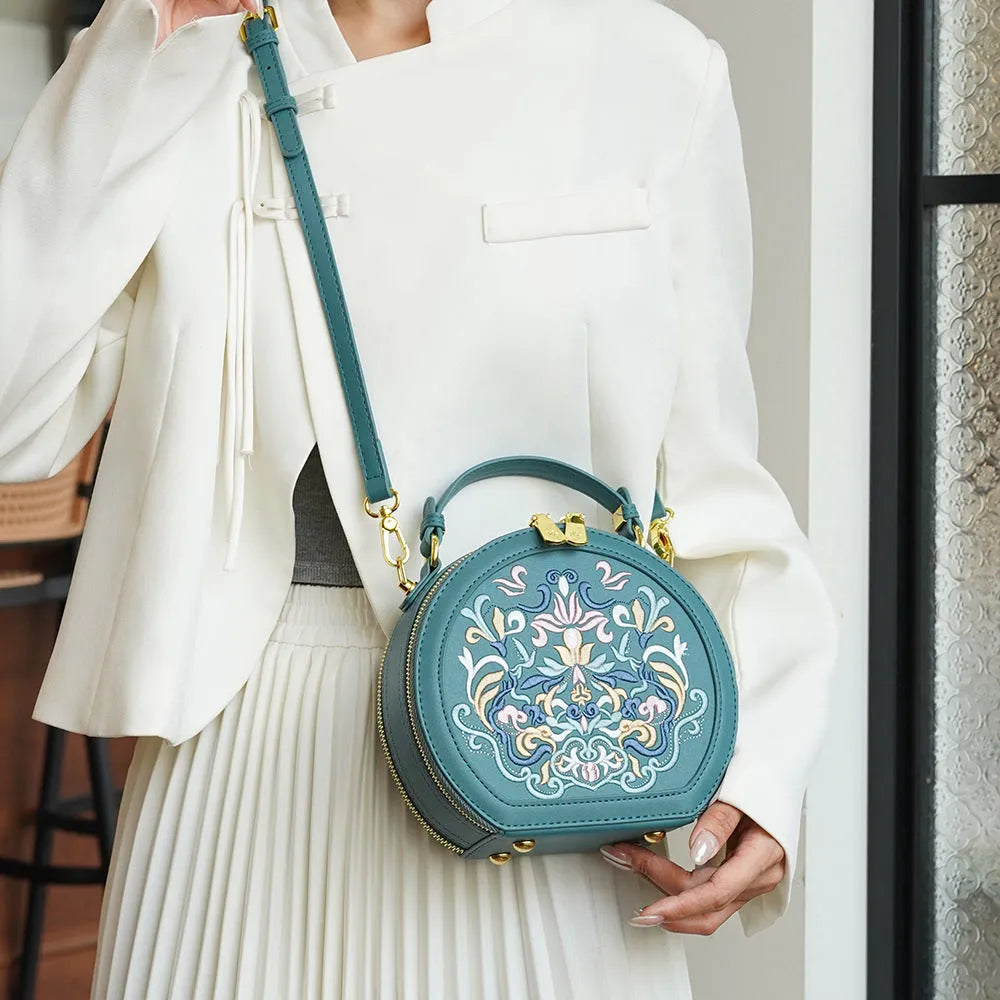 Round PU leather crossbody bag with embroidery and sewing line, available in five colours