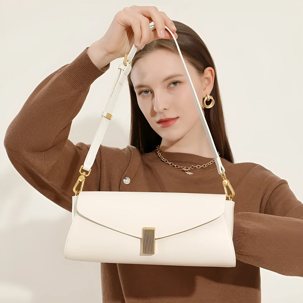 Beige cowhide leather women's cross-body bag with clamshell opening showing internal organisation pockets