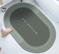 Natural rubber quick-drying bathroom floor mat in blue, available in oval and rectangular shapes.