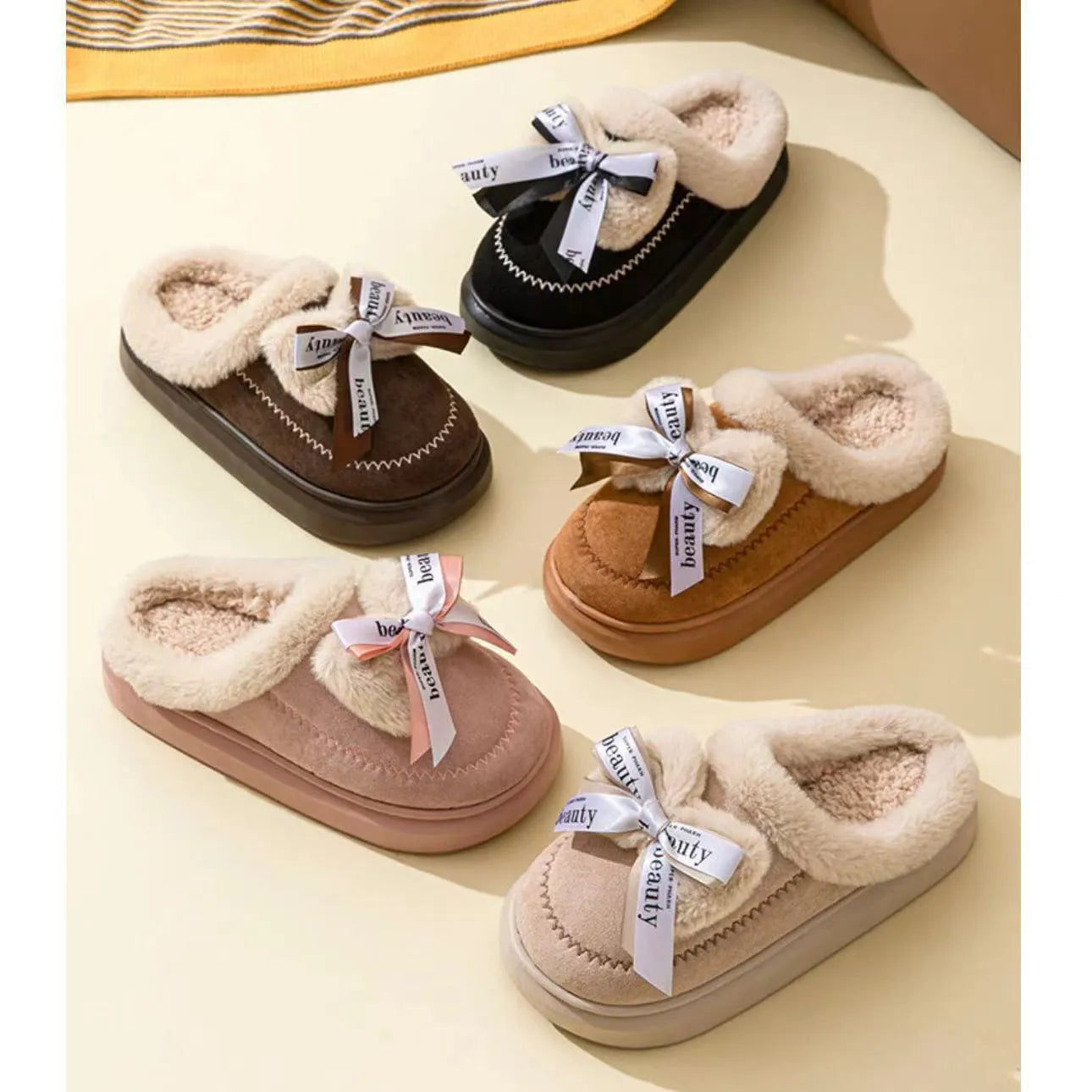 Beige women's suede half slippers with a black ribbon bow and thick cotton sole.