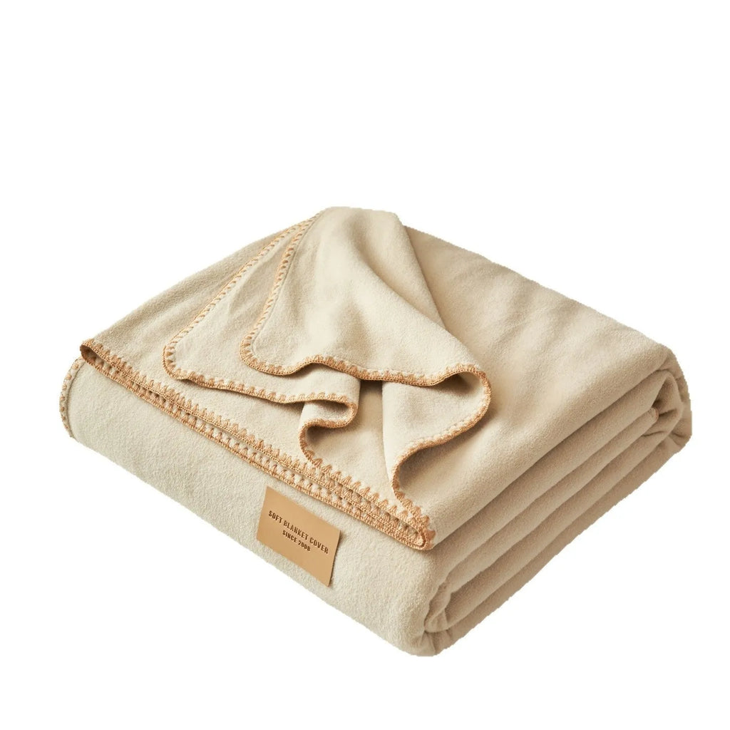 Class A Alpaca Fleecefiber blanket in solid colour, folded on a sofa, showing soft polyester texture