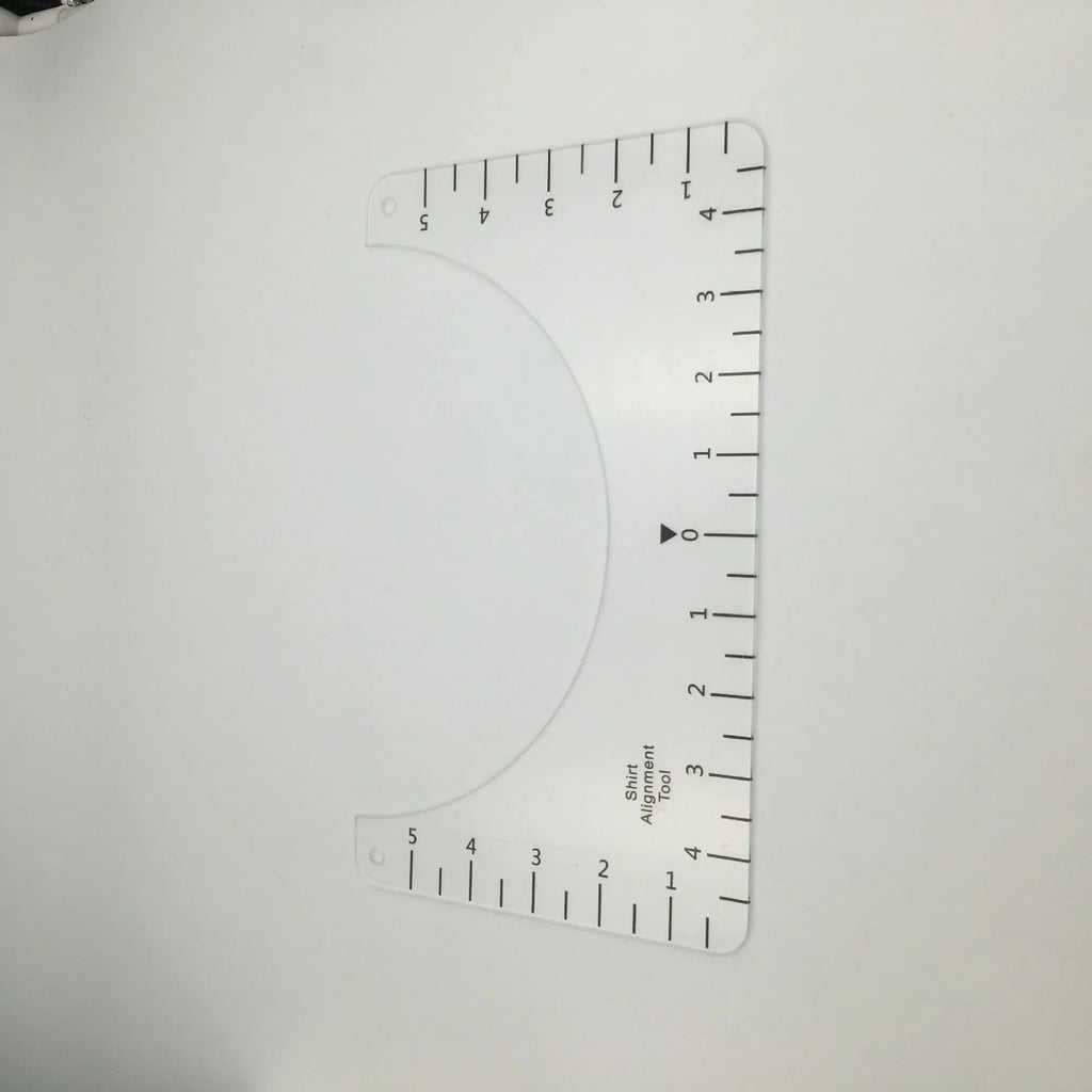 Clear acrylic sewing patch ruler for T-shirt alignment, 10 by 6 inches.