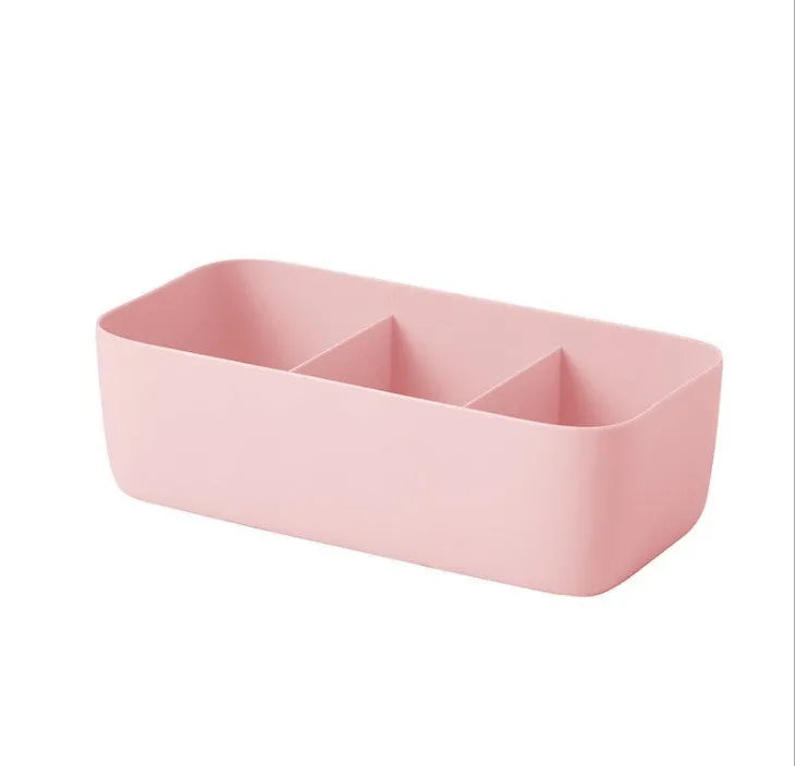 PP plastic socks and underwear storage box with grid compartments in apricot colour on a desktop