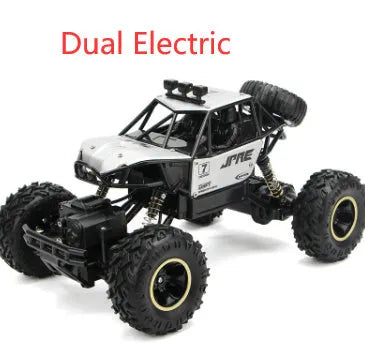 Black and silver remote control off-road car on rough terrain showing four-wheel drive and climbing capability.