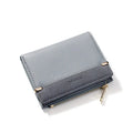 Black ladies bi-fold wallet with a gold zipper, open to show multiple card slots and a coin compartment.