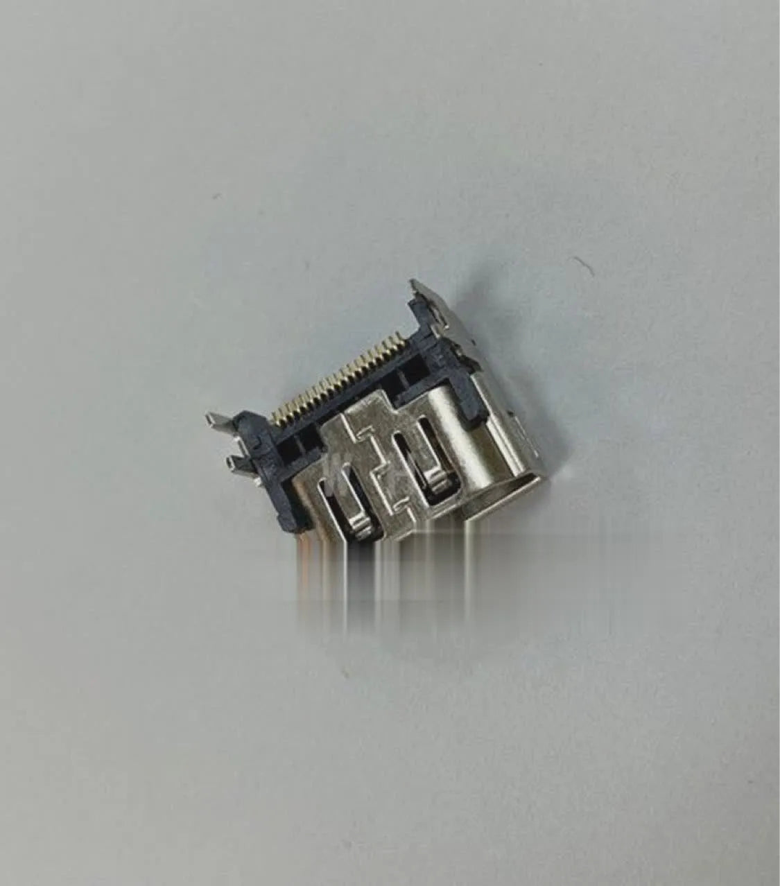 Silver metal HDMI host interface socket connector with mounting holes.