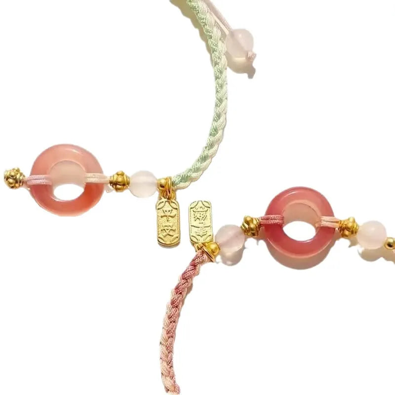 National style DIY woven watch band with peach blossom pattern in black, green, and pink.