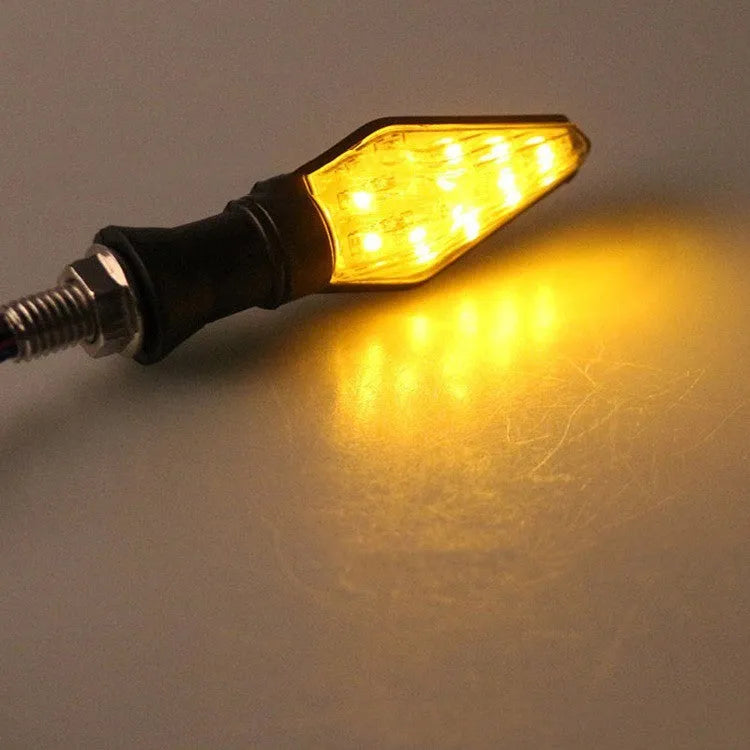 Motorcycle LED turn signal lights showing yellow and blue double-sided luminous indicators
